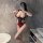 Woman wearing red and black cherry romance lingerie set with sheer bodice, posing in bathroom mirror for date night outfit.