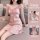 Woman wearing pink leopard print satin cami pajama set with lace trim, part of the cherry romance lingerie set for spring and...