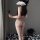 Woman wearing cherry romance sheer mesh bodysuit, holding a black rose, standing in a room with black and white balls.