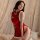 A woman poses wearing a red velvet chinese-style christmas sleep dress with white fur trim, featuring buttons down the front ...