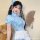 A charming model wears a light blue chinese-inspired maid outfit, featuring a delicate qipao design and playful elements, per...