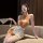 A woman poses elegantly in a chinese-inspired lingerie set featuring pearl embellishments, maid-style design, and sheer fabri...