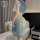 Woman wearing a sheer blue and white chinese-inspired lingerie qipao costume with elegant hanfu style details, perfect for ni...