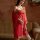 A woman models a chinese-inspired transparent lace lingerie set, featuring a red dress with intricate patterns and matching r...