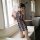 A woman poses elegantly in a floral halter bodysuit, featuring a retro design. the dress combines traditional chinese element...