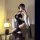 A woman poses in a black chinese-style sexy lingerie dress featuring high slits, backless halter neck, and embroidery, perfec...