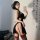 Elegant modified cheongsam with high slit, backless design featuring embroidered halter top, perfect for bold fashion stateme...