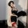 Elegant modified cheongsam with high slit, backless design featuring embroidered halter top, perfect for a chic and daring lo...