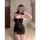 A woman models a black sheer mesh lace halter dress with side slit, featuring delicate lace details and a form-fitting design...