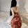 A woman sits on a bed wearing a red chinese silk qipao lingerie set, featuring high-slit sheer fabric with ancient dunhuang s...
