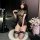 A woman poses elegantly in a black lace chinese-style sleep dress featuring a split back, open crotch design, and a cute cuto...