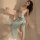 A woman poses elegantly in a sheer chiffon chinese traditional doudou bralette set, featuring delicate floral embroidery and ...