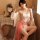 A woman poses elegantly in a sheer chiffon sleepwear set, featuring delicate floral embroidery and vintage-inspired design el...