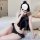 A woman poses with a mirror, wearing a black lace lingerie set inspired by chinese styles. the set features a silky bodysuit ...