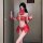 A woman poses in a vibrant red chinese new year-themed costume, featuring an exotic dance-inspired design with intricate patt...