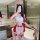Woman in red and white christmas naughty lingerie set with bow details, posing seductively in a modern bathroom.