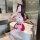 Woman in red and white christmas lingerie set with reindeer antlers, posing seductively in a modern bathroom.