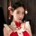 A young woman wears a festive christmas red velvet babydoll dress set, featuring lace details and a charming bow hair accesso...