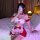 A woman poses in a festive christmas-themed cosplay maid outfit, featuring red bunny ears, a white blouse with ruffles, and a...