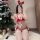 A woman poses in a festive setting wearing a red christmas-themed sexy lace bikini set with faux fur balls, perfect for holid...
