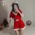 A woman poses in a festive red velvet christmas sleep dress with white trim and pom-poms, perfect for holiday-themed role pla...