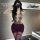 Woman modeling chu rui deep v-neck lace-up bodycon dress with thigh-high stockings and garter belt in boudoir setting.