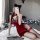 A woman poses in a red classic chinese qipao lingerie set, featuring lace backless design and sexy allure, perfect for intima...
