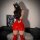 Sexy red patent leather mini skirt with cutout back, paired with matching thigh-high boots and a black cat hat, perfect for n...
