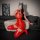 Sexy red bodysuit with patent leather thigh-high stockings, perfect for nightclub wear. features sheer mesh design and plungi...