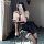 A woman poses in a pink sailor uniform with black pleated skirt, capturing herself in mirror selfie style. perfect for school...