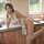 A woman poses playfully in a cow print maid costume, featuring cute bunny ears and playful design, perfect for cosplay with a...