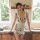 A woman poses in a cow print maid costume, featuring playful bunny ears and a cute apron design, perfect for cosplay with a t...
