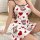 A woman wears a white satin sleep dress adorned with red hearts and brown teddy bears, ideal for summer lounging.