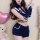 Woman modeling navy blue cute bunny girl costume set with split short shorts, bunny ears headband, and officer-style top for ...