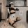 Woman posing in a cute maid costume, featuring a sexy small-bust lingerie set with a flirty french maid style uniform outfit.