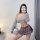 A woman poses with a cute schoolgirl jk outfit featuring a sheer sweater and micro skirt, holding a balloon while using a pla...