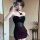 Woman wearing dark glam mesh lace floral halter bodysuit, sexy backless bodycon dress with rose details, posing in mirror sel...
