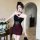 Woman wearing dark glam mesh lace floral halter bodysuit — sexy backless bodycon dress with red roses, sheer waist, and feath...