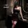 Woman in dark romance lace mesh cheongsam set with rose halter corset, sheer mesh, and red lace garter thigh-highs.