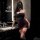 Woman in dark romance lace mesh cheongsam set with rose-embellished halter corset and high-waisted thong bodysuit, posing in ...