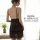 Woman wearing black sheer lace sleep dress with adjustable straps, showing elegant back view in soft light.