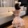 Girl in pink domila maid lingerie set with fluffy ears, posing by sofa.