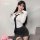 A woman poses wearing a white blouse with a black tie, paired with a form-fitting gray skirt, ideal for roleplay scenarios su...