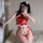 A woman poses with a fan, wearing a red halter neck cheongsam-inspired lace bodysuit featuring raw edge and cut-out details. ...