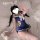 A person wearing a blue domoira jk school skirt set, featuring bunny ears and a bow, lying on white fabric with a plush toy n...