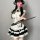 A woman wears a cute panda-themed domoira chinese-style maid outfit, featuring a black and white dress with ruffles and a fan...