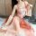 Dreamlike vintage-inspired lingerie set featuring an embroidered bra with floral design, paired with flowing peach-colored sl...
