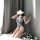 Woman in dva overwatch cosplay bodysuit, floral lingerie set, kneeling in ball pit with phone covering face.