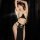 Woman modeling egyptian cat lady costume, a sexy hollow-out halter gown with gold chains and gem accents for ancient role pla...