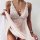 Woman wearing elegant lace sheer sleepwear set, featuring delicate floral patterns and a heart-shaped pendant necklace.